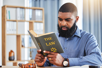 Image showing Man, reading and lawyer with a book on the law, rules or research on legal constitution, regulation or policy from government. African businessman, judge or attorney with knowledge of justice