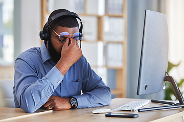 Image showing Call center, man and headache, pain or stress for communication mistake, error and sales crisis on computer. Agent, consultant or african person in glasses and computer with eye care in telemarketing