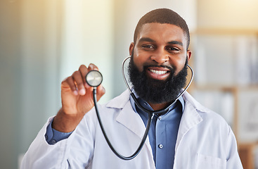 Image showing Doctor, man and portrait with stethoscope for heartbeat, healthcare services and cardiology. Face of happy medical african worker with tool to listen, check breathing and lungs for test in hospital