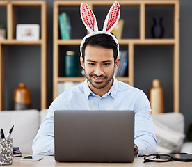 Image showing Laptop, bunny ears and business man in office with decoration for celebration, event and Easter party. Corporate, happy and Asian male person on computer at desk with rabbit headband for holiday