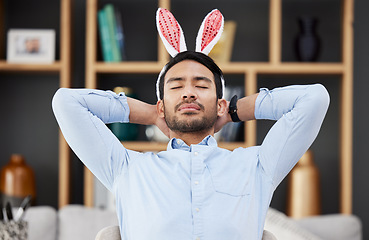 Image showing Bunny ears, easter and business man sleeping or tired in an office feeling lazy on holiday and bored after party in office. Hangover, rabbit and employee or person with fatigue, burnout or overworked