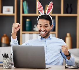 Image showing Bunny ears, easter and winning by business man excited, happy and celebrate in an office with success. Winner, rabbit and employee or person with victory, achievement and using a laptop for profit