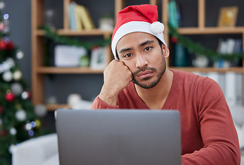 Image showing Bored, christmas hat and portrait of a tired man in the office with a laptop working on a project. Burnout, exhausted and young male creative designer with xmas decorations in the modern workplace.