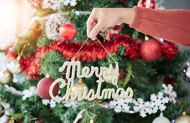 Image showing Christmas, tree and hand of man with decoration for celebration, party or event preparation. Festive, holiday and male holding ornament in a living room celebrating a fun December vacation or break