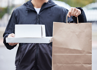 Image showing Courier man, paper bag and hands for pizza, service and delivery in urban city for supply chain job. Logistics worker, package and street for customer satisfaction, product or e commerce in metro cbd
