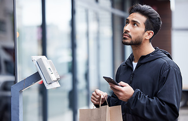 Image showing Courier man, paper bag and city with phone, typing and delivery app with search in supply chain job. Young logistics worker, package and thinking with smartphone, product and ecommerce in metro cbd