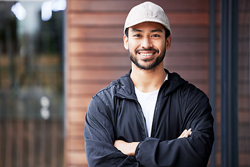 Image showing Portrait, arms crossed and asian man courier outdoor for delivery and service with a smile. Face, proud and happy Japanese male carrier ready for ecommerce, order or logistics, mail or distribution