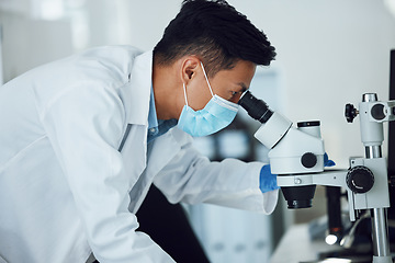 Image showing Microscope, science and asian man with face mask in laboratory for research, medical analysis and biotechnology. Scientist, microbiology and investigation of innovation, dna testing and development