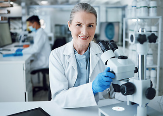 Image showing Microscope, scientist and portrait of senior woman in laboratory to review virus research, medical test and biotechnology. Science, microbiology and happy female professor planning expert assessment