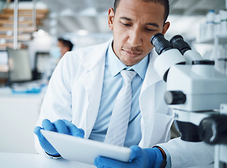 Image showing Microscope, science and man with tablet in laboratory for research, medical analysis and biotechnology. Scientist, microbiology and investigation with digital technology, dna testing and development