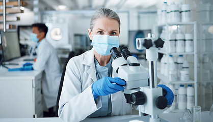 Image showing Microscope, scientist and portrait of woman in laboratory to review virus research, medical test and biotechnology. Science, microbiology and senior female professor with face mask for dna analysis