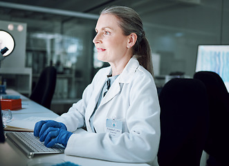 Image showing Woman, night and keyboard in science laboratory for medical research, deadline and pharmacy wellness. Mature scientist, person and working late on technology for DNA healthcare or genetic engineering