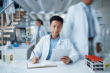 Image showing Asian man, tablet and writing in science laboratory for medical virus research, medicine and vaccine development. Busy scientist, technology and notebook paper for blood sample healthcare or wellness