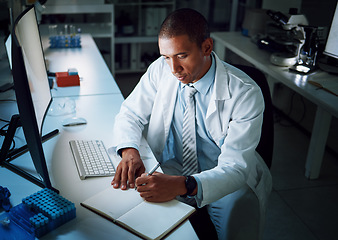 Image showing Doctor, writing notes and night in laboratory for medical research and study for healthcare report. Paperwork, African male professional and planning with data for biotechnology in clinic or hospital