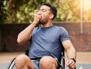 Image showing Lung, breathing and asian man in a wheelchair with asthma, pump at outdoor court for health and fitness routine. Breathe, inhaler and male with disability at a park with allergies while training