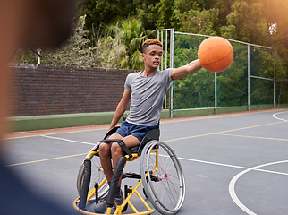 Image showing Basketball, wheelchair and man with sports ball at outdoor court for fitness, training and cardio. Exercise and person with a disability at a park for game, workout and weekend fun or active match