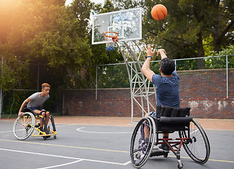 Image showing Sports, basketball and men in wheelchair for goal in training, exercise and workout on outdoor court. Fitness, team and male people with a disability shoot ball for competition, practice and games