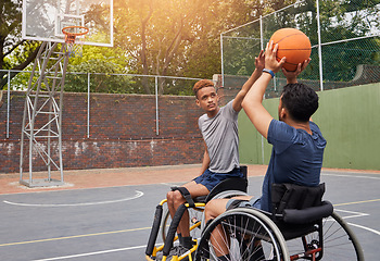 Image showing Sports, wheelchair basketball and people shooting ball in match competition, challenge game or fitness practice. Player defence, shot and young athlete with disability, training and exercise on court