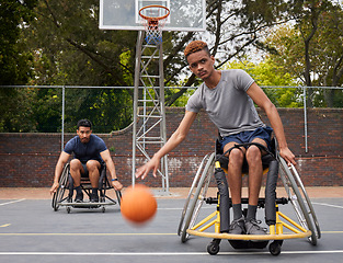 Image showing Sports action, wheelchair basketball or man focus on match competition, outdoor court challenge or fitness. Determined player, dribbling ball or African athlete with disability, training and exercise