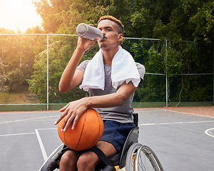 Image showing Basketball player, drinking water or man in wheelchair for sports break, rest or fitness electrolytes on court. Person with a disability, athlete or bottle for recovery, exercise and workout wellness