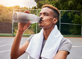 Image showing Outdoor, fitness and man with water, training or body recovery with exercise, workout goal or tired. Healthy person, exhausted or African athlete with liquid, hydration or thirsty on court for sports