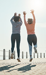 Image showing Fitness, jump and success with friends at beach for celebration, motivation and training. Cardio, workout and health with mature women in nature for running, energy and exercise goals together