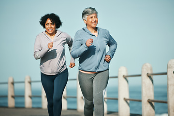 Image showing Fitness, running and senior women at beach for health, wellness and exercise in nature together. Elderly, friends and ladies at sea happy, workout and active retirement, fun and bonding ocean run