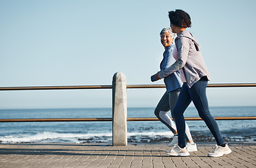 Image showing Women, beach and friends running for fitness together as morning exercise for wellness and outdoor bonding. Health, endurance and people training for marathon in Cape Town for sports workout