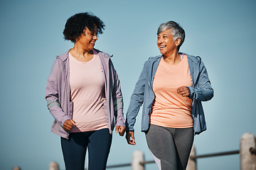 Image showing Fitness, exercise and senior women by ocean for healthy lifestyle, wellness and cardio on promenade. Sports, friends and female people in conversation on boardwalk for walking, training and workout