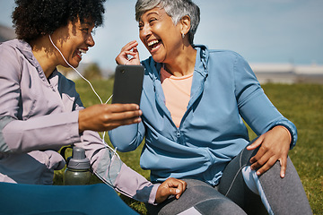 Image showing Music, fitness and senior friends laughing on the grass outdoor taking a break from their workout routine. Exercise, training and funny with elderly people streaming audio on a field for wellness