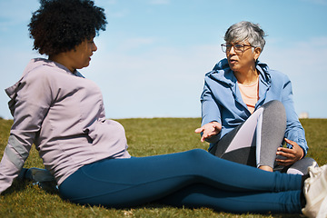 Image showing Talking, fitness and senior women friends on the grass outdoor taking a break from their workout routine. Exercise, training and summer with elderly people in conversation on a field for wellness