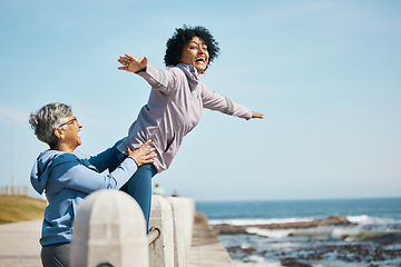 Image showing Beach, love and senior mother with woman doing airplane gesture playing, crazy and funny with parent for outdoor exercise. Health, wellness and goofy women bonding by the sea or ocean for workout