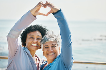 Image showing Heart, hands and health with portrait of friends at beach for fitness, support and love. Motivation, happy and wellness with mature women and sign in nature for exercise, workout and emoji mockup