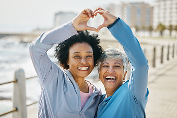 Image showing Heart, hands and fitness with portrait of friends at beach for health, support and love. Motivation, happy and wellness with mature women and sign in nature for exercise, workout and emoji icon