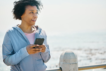 Image showing Running, phone and fitness with black woman at beach for relax, workout and social media. Network, communication and contact with female runner training in nature for technology, sports or mobile app