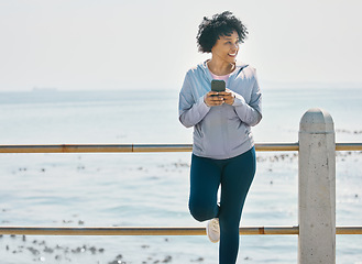 Image showing Happy, phone and fitness with black woman at beach for running, workout and mockup. Network, communication and contact with female runner training in nature for technology, sports and mobile