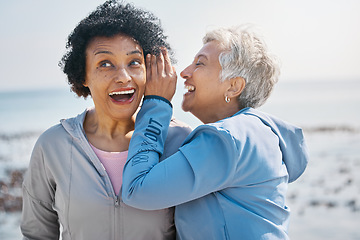 Image showing Gossip, beach and senior friends with a secret, whisper or talking in ear for a funny joke after outdoor exercise. Laughing, crazy and elderly women listening to conversation or story at the sea