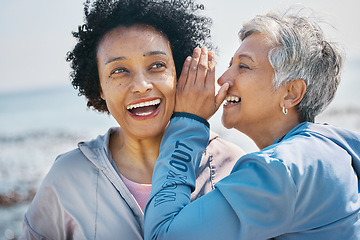 Image showing Gossip, outdoor and senior friends with a secret, whisper or talking in ear for a funny joke after beach exercise. Laughing, crazy and elderly women listening to conversation or story at the sea