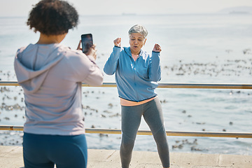 Image showing Senior woman, dancing and influencer outdoor for fitness, fun energy and celebrate retirement. Exercise, mature and funny people at sea for happy photograph, adventure or social media travel memory