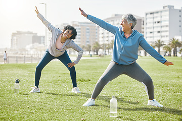 Image showing Women, senior and stretching in park, laugh with fitness and wellness, flexibility and start workout outdoor. Female people, friends warm up together and comedy with training and exercise in nature