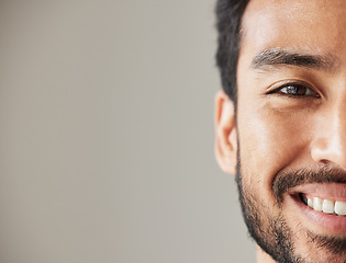 Image showing Half face, portrait and smile of an asian man in studio with positive mindset, wellness and awareness. Young male model isolated on grey background with happiness, mockup space and confident headshot