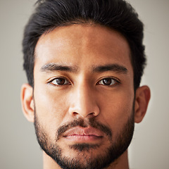 Image showing Face, portrait and serious asian man in studio with focus, wellness and awareness. Headshot of a young male model isolated on a grey background with concentration, vision and stern expression