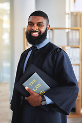 Image showing Happy, man and portrait with a book on the law, rules or research on legal constitution, regulation or policy from government. African businessman, lawyer or attorney with knowledge of justice