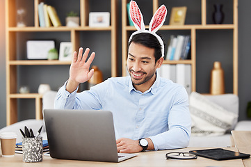 Image showing Easter bunny, ears and man on online meeting at home with computer screen and greeting. Remote work, holiday and rabbit costume in virtual call in house for digital education class with male teacher