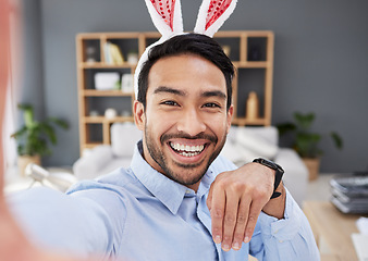 Image showing Bunny ears, holiday and remote work selfie with a man and social media with creative job. Celebration, happy face and male person from Spain feeling silly and goofy with comedy easter hat at home