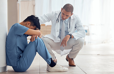 Image showing Sad nurse on floor and doctor support, helping or empathy for healthcare fail, mental health and stress or anxiety. Tired, fatigue and mentor or medical people with depression in hospital or clinic