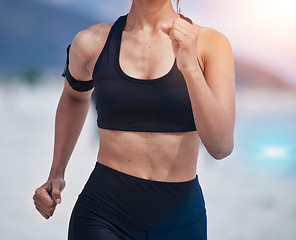 Image showing Running, body and woman at a beach for fitness, training and performance, health and workout on blurred background. Sports, wellness and female runner at sea for resilience, challenge or ocean run