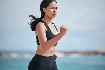 Image showing Running, exercise and woman at a beach for fitness, training and body performance workout for healthy energy. Sports, wellness and female runner at the sea for resilience, challenge or ocean run