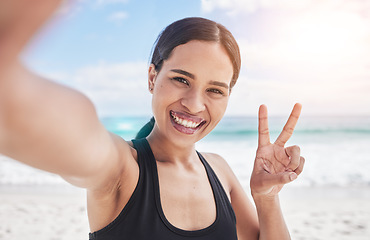 Image showing Exercise, selfie and woman at beach with peace hands for running, sports or fitness in nature. Portrait, happy and lady health and wellness influencer smile for social media, blog or profile picture