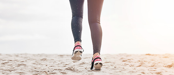 Image showing Fitness, legs and feet running on beach sand for exercise, sports athlete or energy with mockup space from the back. Banner, closeup or shoes of runner at ocean for cardio workout, training or action